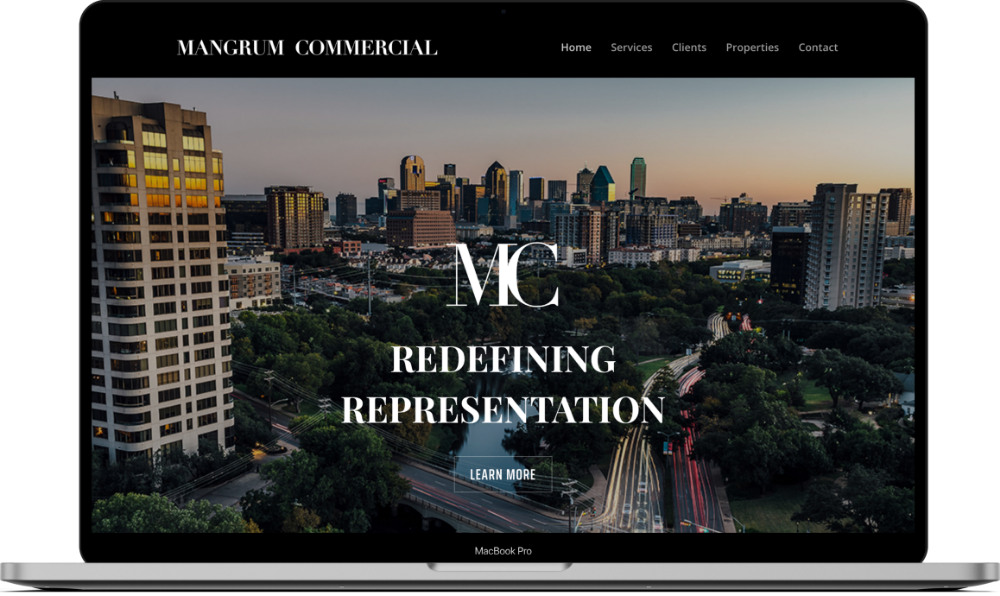 Mangrum Commercial website design mockup on a MacBook